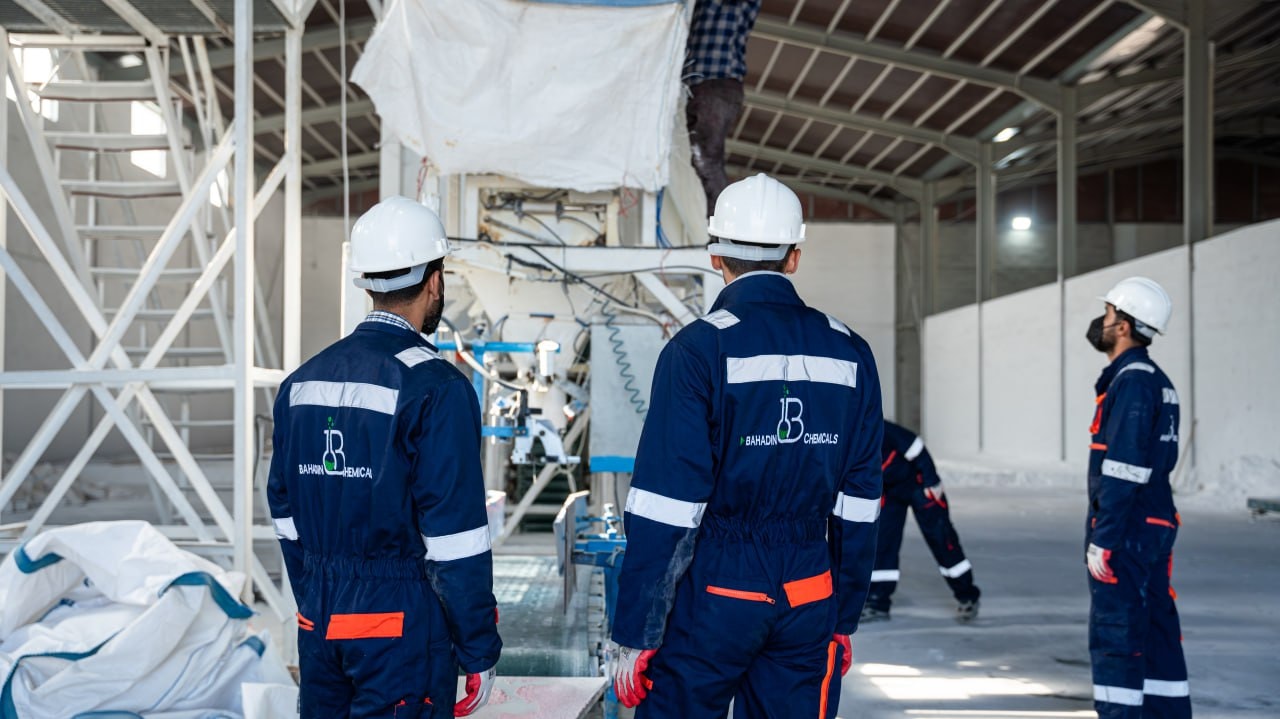 Bahadin Chemicals staff in branded overalls and hard hats at the plant