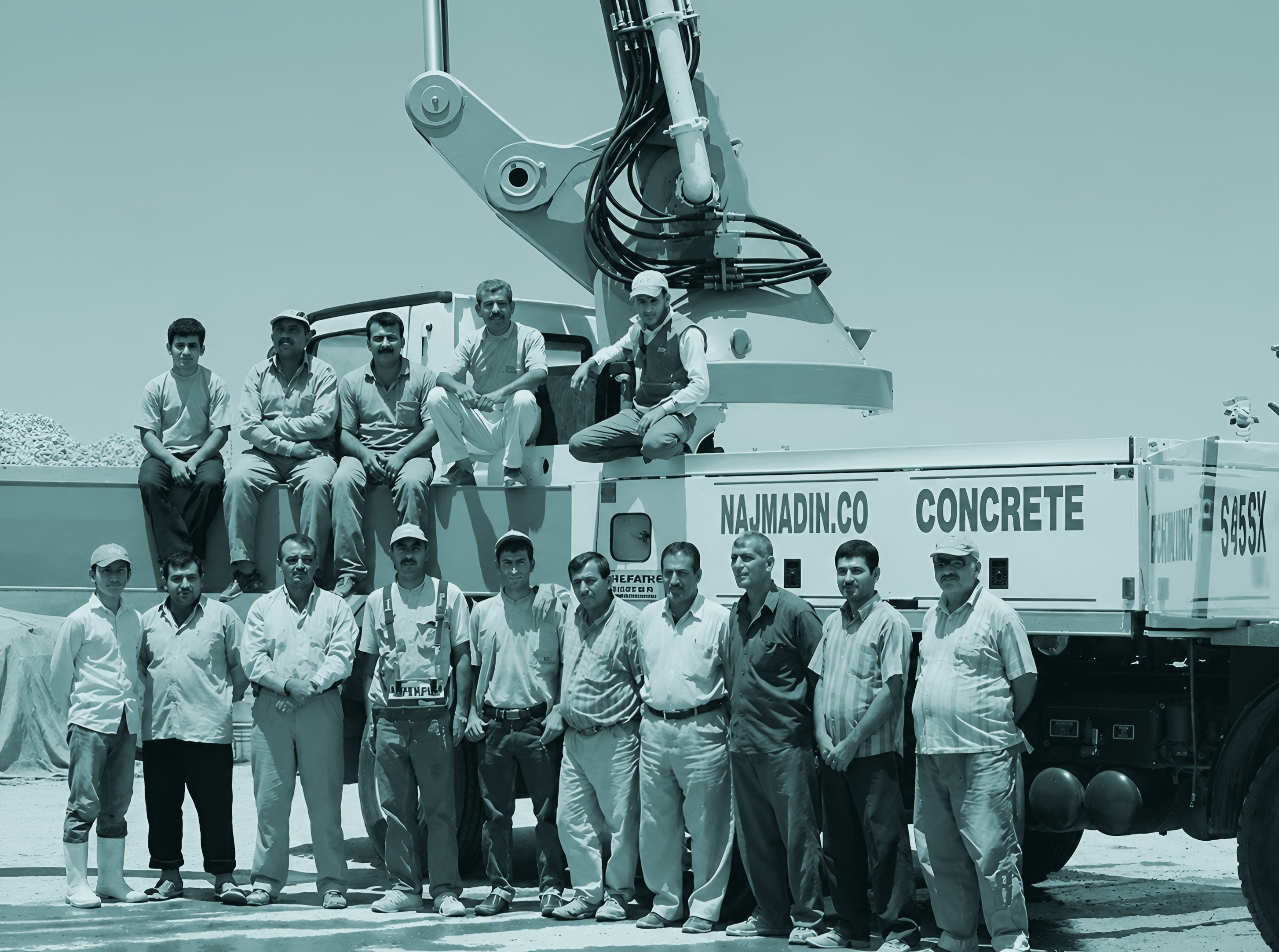 The Bahadin Concrete team in front of a concrete pump truck